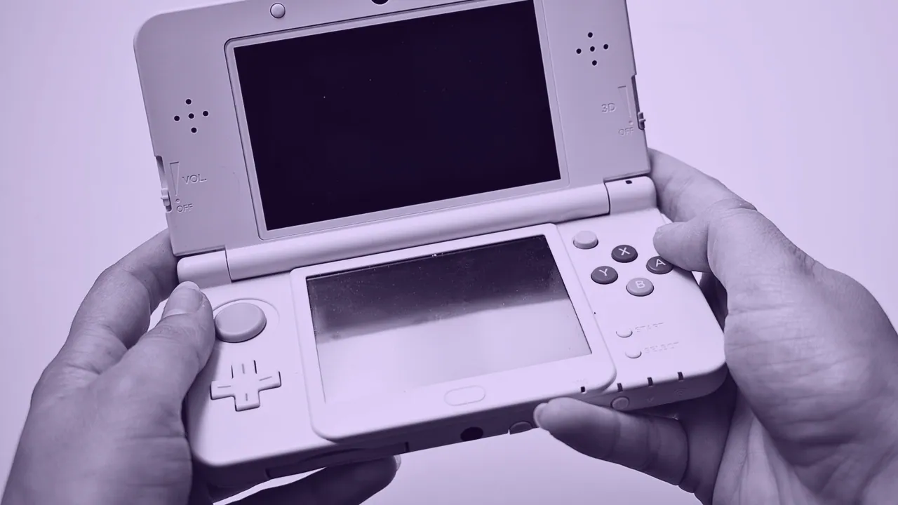 A handheld games console held in two hands.