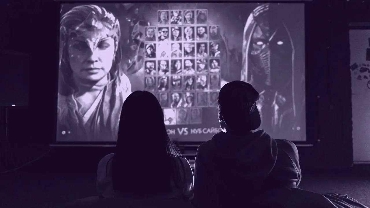 Moving video on a screen in a darkened room.