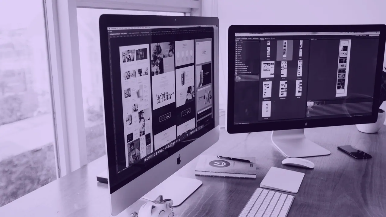 Two angled displays on a desk, one larger than the other.