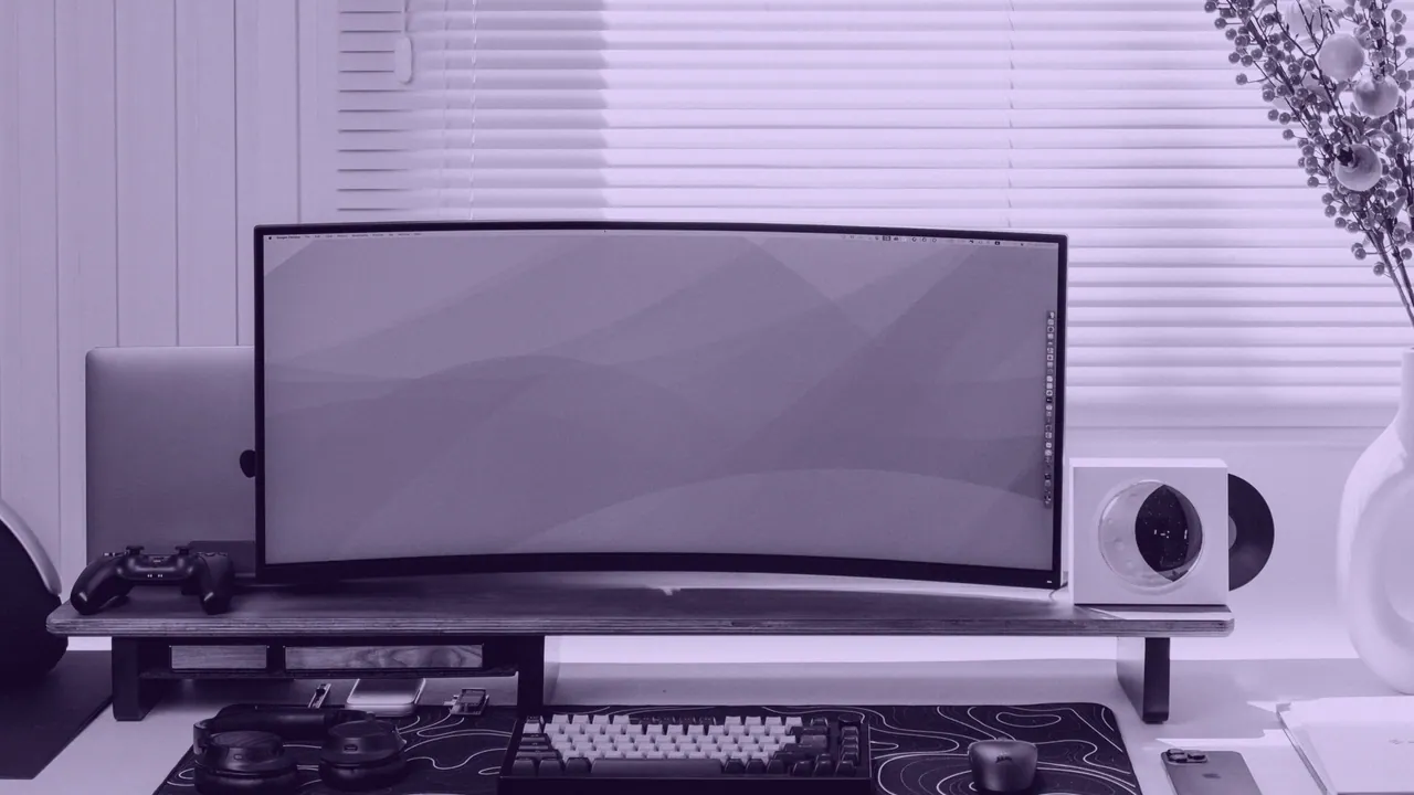 A curved ultrawide monitor on a desk.